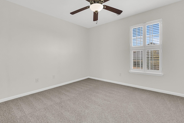 empty room featuring a ceiling fan, baseboards, and carpet flooring