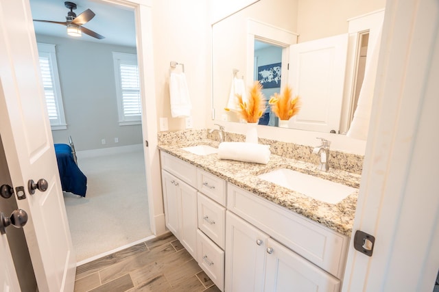 1566 Lindsey Creek Dr, Mount Pleasant, SC 29466 - ensuite bathroom featuring double vanity, a ceiling fan, baseboards, and wood finished floors