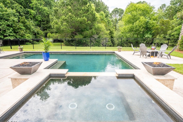 1566 Lindsey Creek Dr, Mount Pleasant, SC 29466 - view of swimming pool featuring an outdoor fire pit, a pool with connected hot tub, a patio, a fenced backyard, and view of wooded area