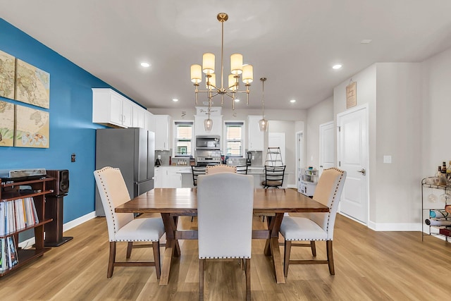 dining room featuring an inviting chandelier and light hardwood / wood-style floors