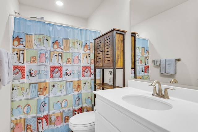 bathroom featuring toilet, vanity, and a shower with shower curtain