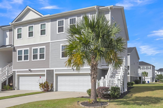 multi unit property featuring a garage and a front yard