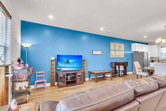 living room featuring plenty of natural light and light hardwood / wood-style flooring