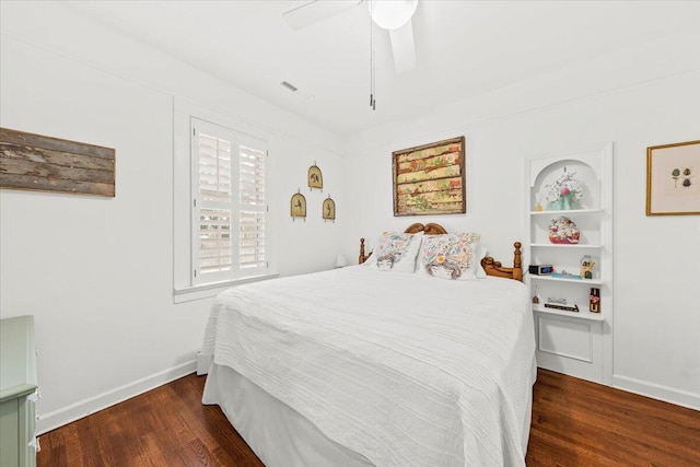 bedroom with wood finished floors, a ceiling fan, and baseboards