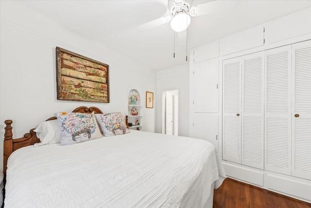 bedroom with dark wood-style flooring, a closet, and a ceiling fan