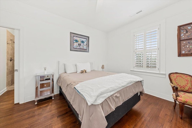 bedroom featuring dark wood-style floors, visible vents, and baseboards