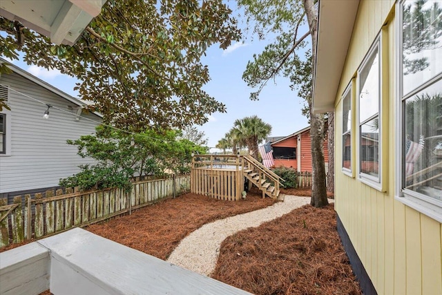 view of yard featuring fence and a wooden deck