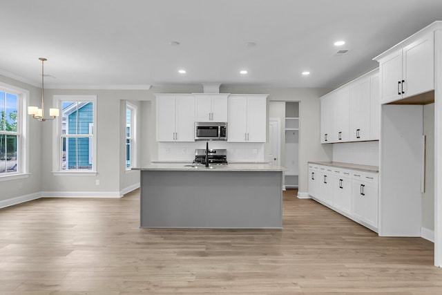 kitchen with stainless steel appliances, backsplash, light wood finished floors, baseboards, and light countertops