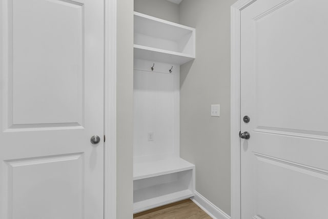 mudroom featuring wood finished floors and baseboards
