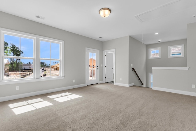 unfurnished room with attic access, light colored carpet, baseboards, and recessed lighting