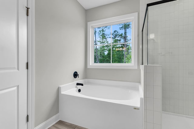 full bath with a walk in shower and a bath