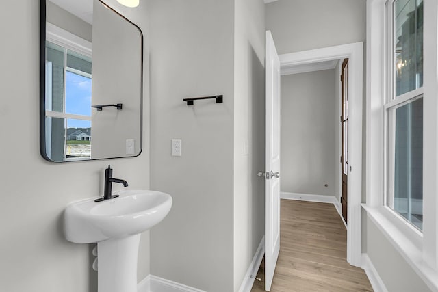 bathroom with wood finished floors and baseboards