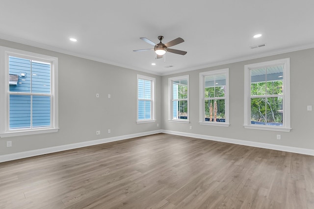 spare room featuring ornamental molding, a ceiling fan, plenty of natural light, wood finished floors, and recessed lighting