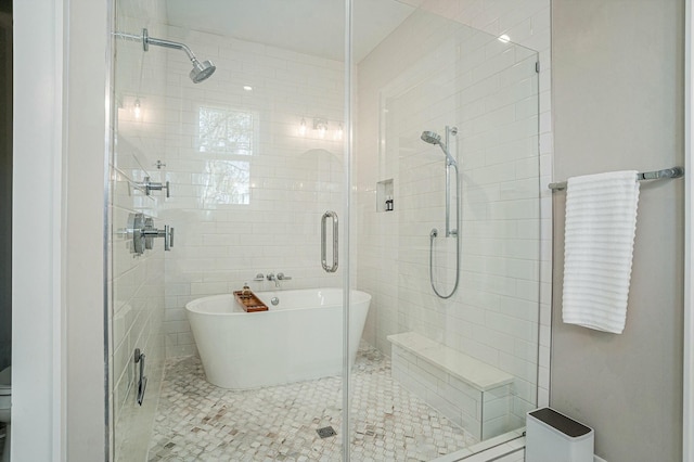 full bath featuring a soaking tub, tile walls, and a stall shower