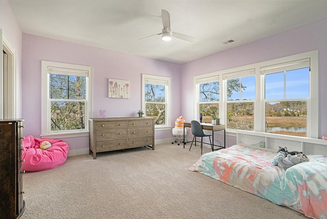 carpeted bedroom with visible vents, baseboards, and ceiling fan