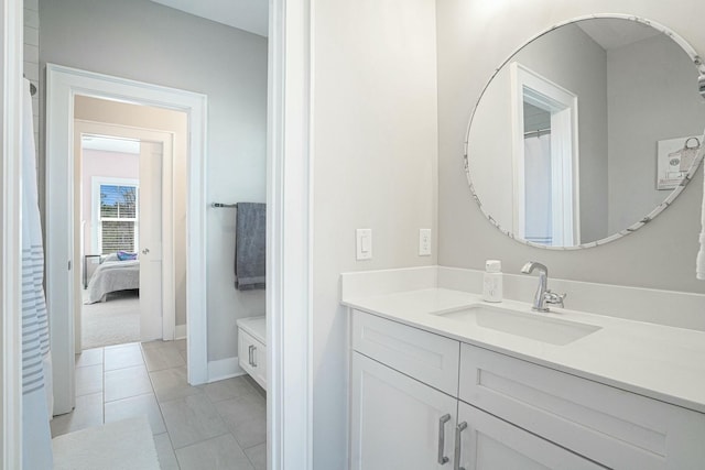 bathroom with tile patterned floors, vanity, and baseboards