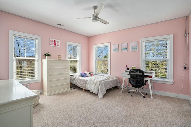 bedroom featuring multiple windows, light carpet, and visible vents