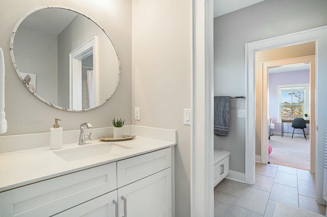 bathroom with tile patterned flooring, vanity, and baseboards