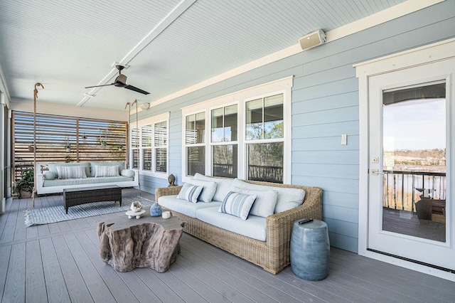 deck with outdoor lounge area and a ceiling fan