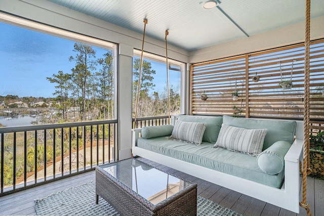 sunroom / solarium with a water view