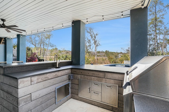 view of patio with an outdoor kitchen, a grill, ceiling fan, and a sink