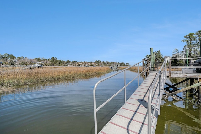 dock area with a water view and boat lift