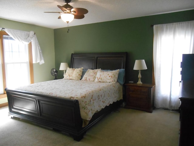 bedroom with light colored carpet and ceiling fan