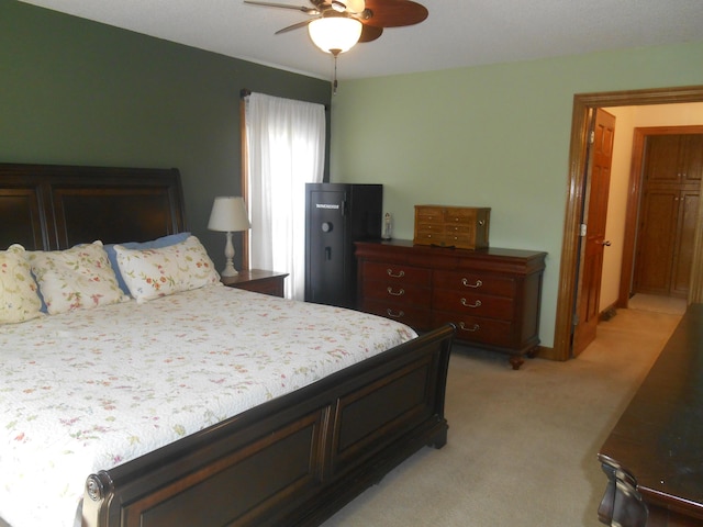 bedroom with light carpet and ceiling fan