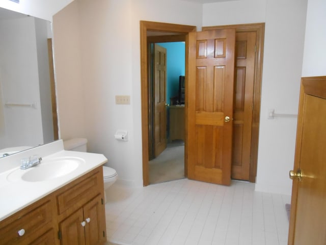 bathroom with toilet and vanity