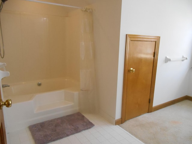 full bathroom with baseboards and shower / bath combo