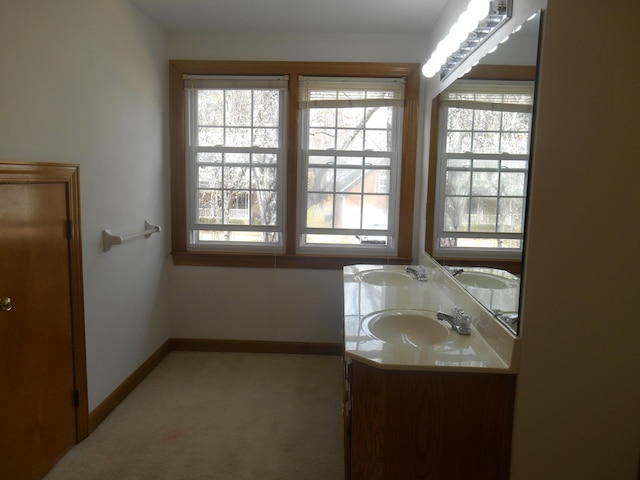 full bath with a healthy amount of sunlight and a sink