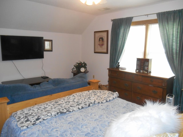 bedroom featuring visible vents and vaulted ceiling