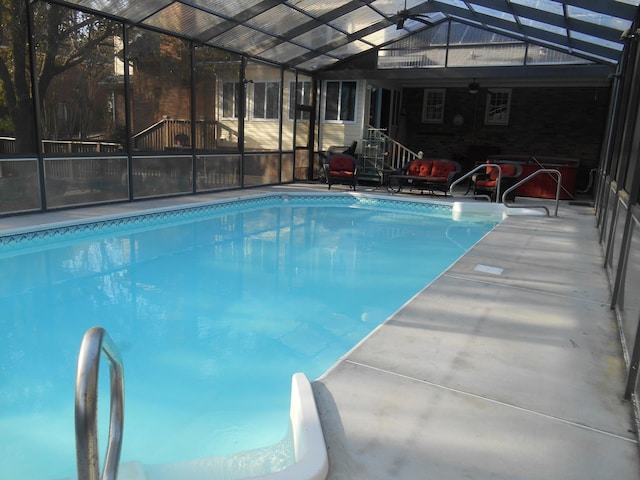 outdoor pool with a patio, a lanai, and a ceiling fan