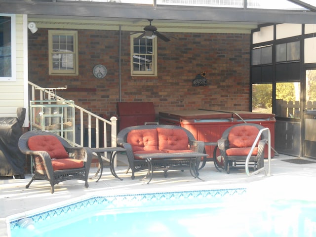 exterior space featuring a patio, ceiling fan, outdoor lounge area, and a hot tub