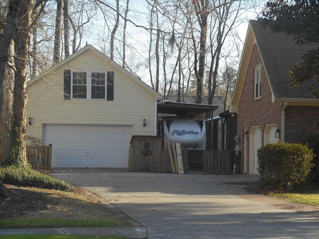 view of front of house with a garage, brick siding, and concrete driveway