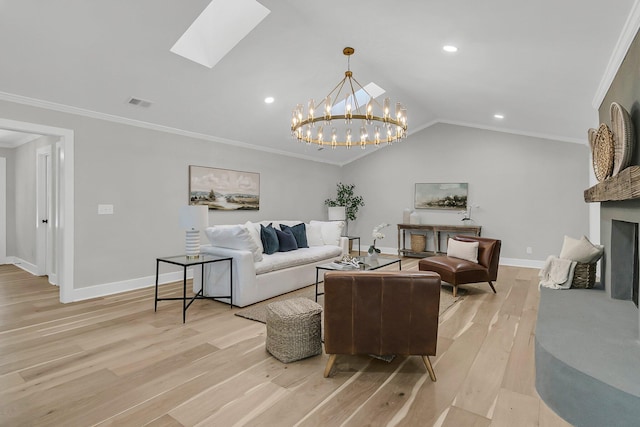 living room with vaulted ceiling with skylight, light wood-style flooring, and ornamental molding