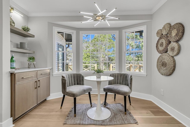 living area with a wealth of natural light, light wood-style flooring, and crown molding