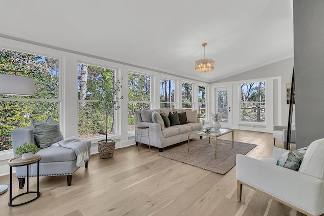 sunroom with an inviting chandelier and vaulted ceiling