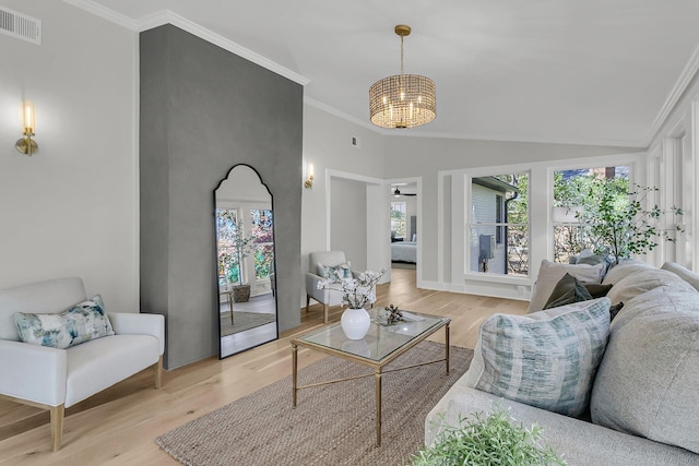 living room with visible vents, light wood-type flooring, and ornamental molding