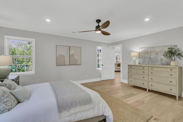 bedroom featuring crown molding, baseboards, recessed lighting, light wood-style floors, and a ceiling fan