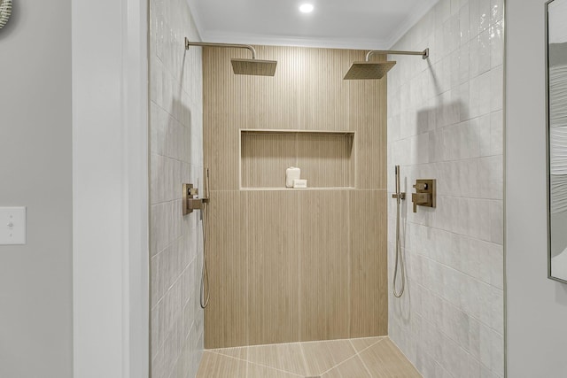 full bath featuring a tile shower and ornamental molding