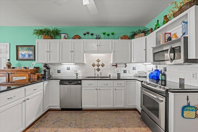 19 Cameroon Dr, Beaufort, SC 29907 - kitchen with appliances with stainless steel finishes, dark countertops, tasteful backsplash, and white cabinetry