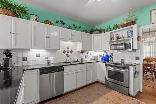 19 Cameroon Dr, Beaufort, SC 29907 - kitchen with appliances with stainless steel finishes, light wood-style floors, white cabinets, and backsplash