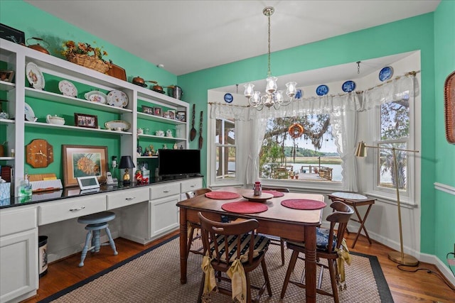 19 Cameroon Dr, Beaufort, SC 29907 - dining area featuring built in desk, a chandelier, and wood finished floors