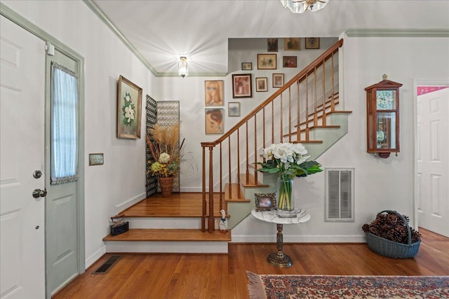 19 Cameroon Dr, Beaufort, SC 29907 - entrance foyer featuring stairway, wood finished floors, a chandelier, and ornamental molding