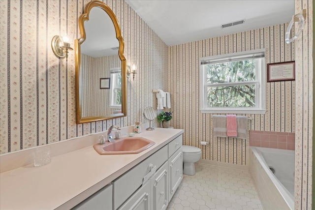 19 Cameroon Dr, Beaufort, SC 29907 - full bath featuring wallpapered walls, vanity, a relaxing tiled tub, and tile patterned floors