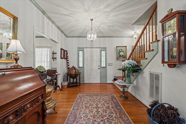 19 Cameroon Dr, Beaufort, SC 29907 - entrance foyer featuring a chandelier, stairs, wood finished floors, and crown molding