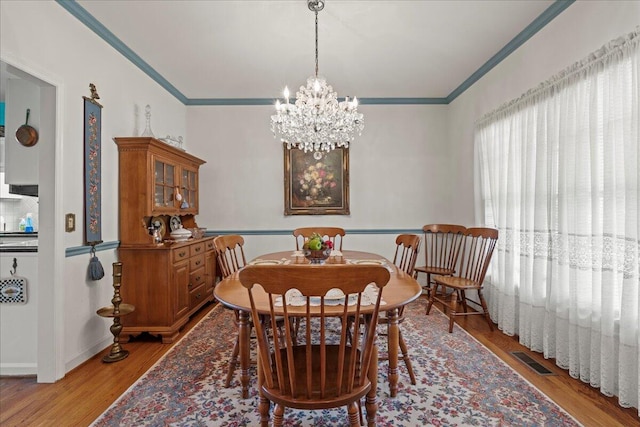 19 Cameroon Dr, Beaufort, SC 29907 - dining room featuring ornamental molding, a chandelier, and light wood-style flooring