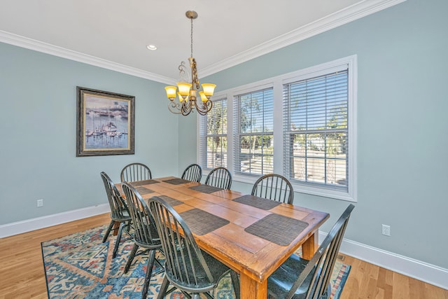 dining area with a chandelier, light hardwood / wood-style floors, and ornamental molding