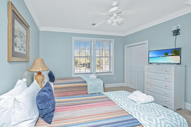 carpeted bedroom featuring a closet, ceiling fan, and ornamental molding